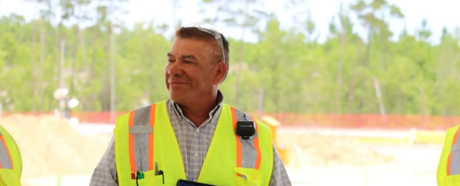 Construction worker in yellow safety vest holding 