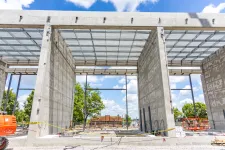 Thumbnail for Concrete structure of a building under construction with exposed steel framework and blue sky background